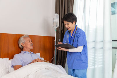 Side view of doctor examining patient at home