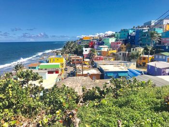 Panoramic shot of townscape by sea against sky