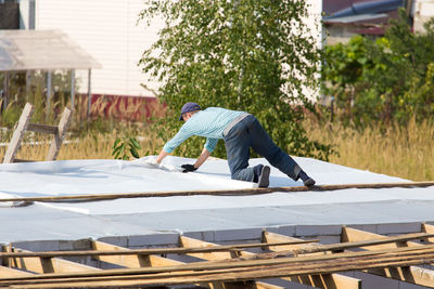 Side view of man against building