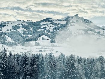 Scenic view of snow covered mountains against sky