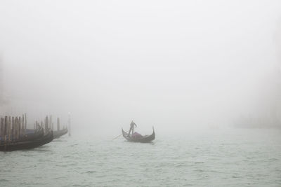 Man sailing on sea during foggy weather