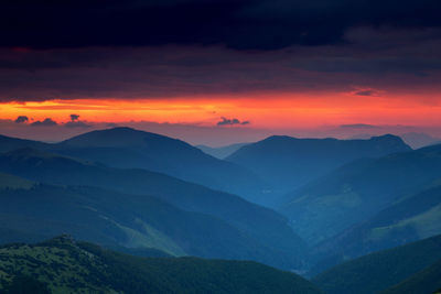 Scenic view of mountains against sky at sunset