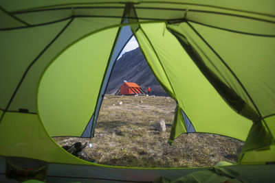 View of emergency shelter and climber through tent door.