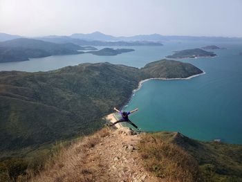 Rear view of woman standing on mountain