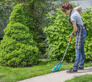 Side view of woman standing by plants