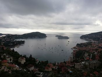 High angle view of townscape by sea against sky