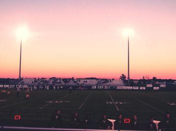 Traffic on road against sky at sunset