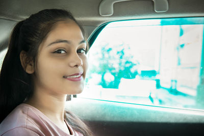 Portrait of young woman in car