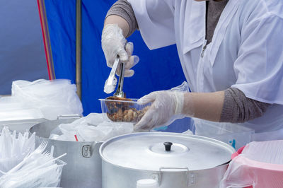 Midsection of woman packing food