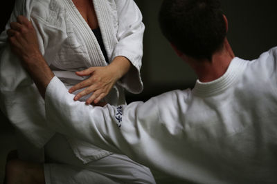 High angle view of man and woman practicing aikido