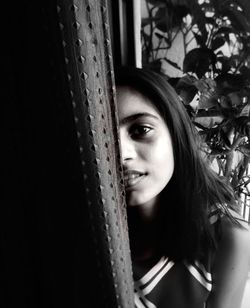 Portrait of beautiful woman in window