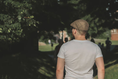 Rear view of man looking at camera