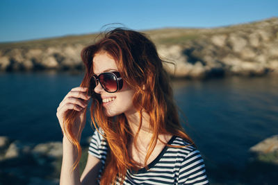 Portrait of young woman wearing sunglasses