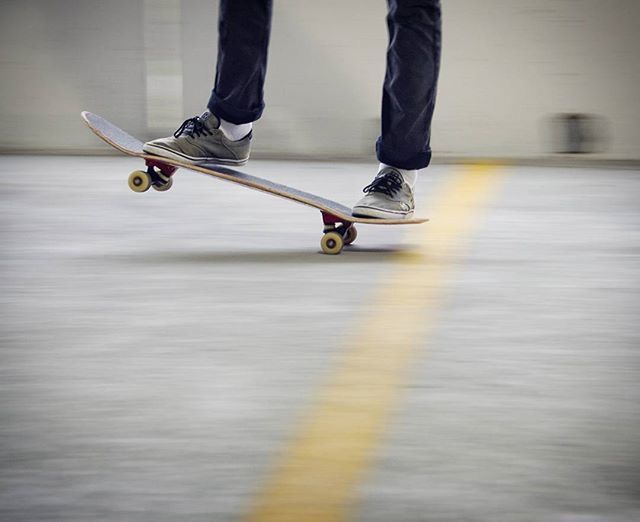 low section, men, lifestyles, person, indoors, walking, shoe, leisure activity, motion, casual clothing, standing, blurred motion, skateboarding, skateboard, selective focus, street