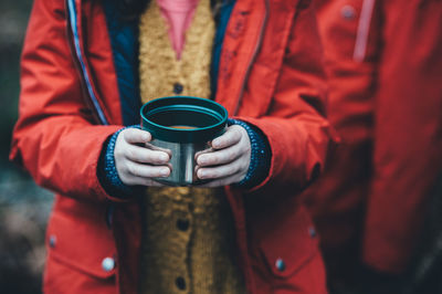 Close-up of hand holding coffee cup