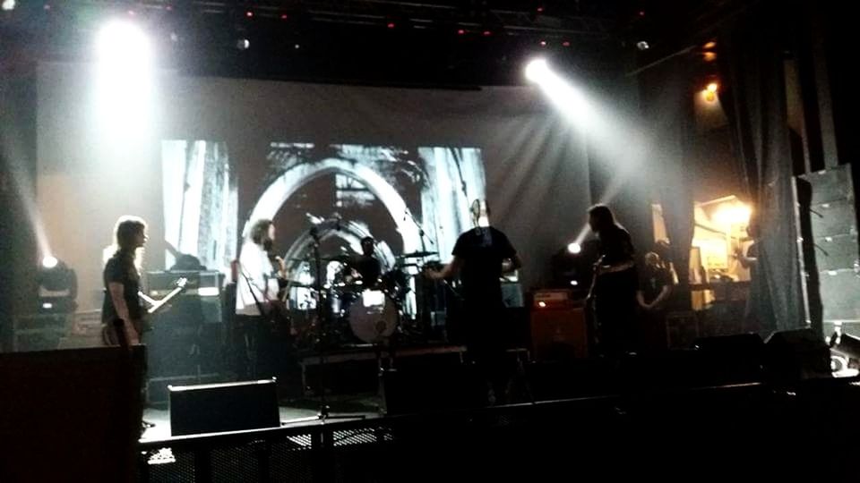 PEOPLE STANDING AT ILLUMINATED STAGE