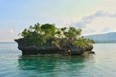 Rock formation at wishing island against sky