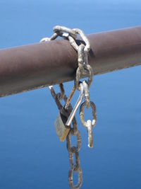 Close-up of hand against blue sky