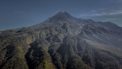 Scenic view of volcanic mountain against sky