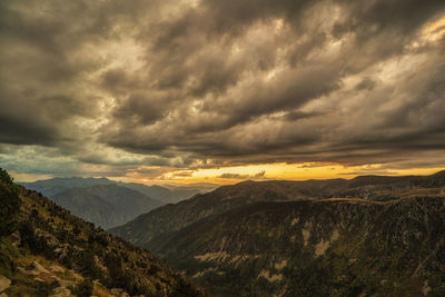 Scenic view of mountains against dramatic sky