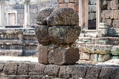 View of buddha statue against stone wall