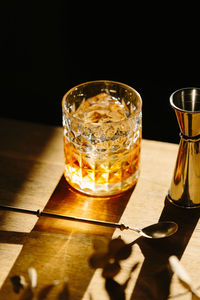 Close-up of glass with bourbon whiskey on table