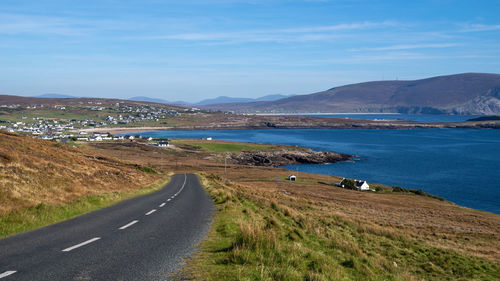 Road by sea against sky