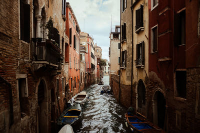 Low angle view of buildings in venice through canal