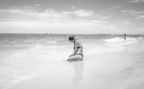 People standing on beach against sky