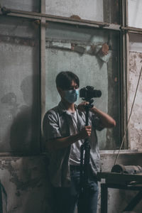 Full length of man standing against wall