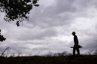 Man standing on field against sky