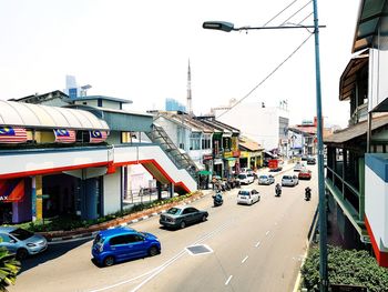 Traffic on road against buildings in city