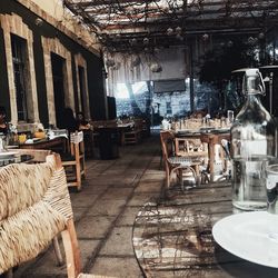 Empty chairs and tables in abandoned building