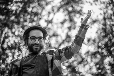 Portrait of smiling man against tree