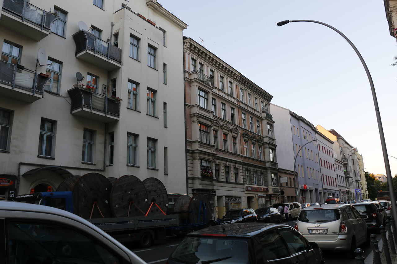 STREET AMIDST BUILDINGS AGAINST SKY