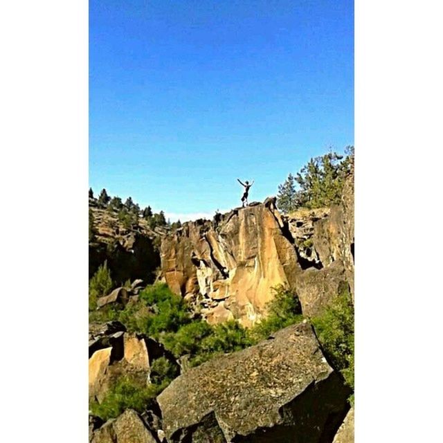 clear sky, copy space, transfer print, blue, auto post production filter, rock - object, tranquility, built structure, day, nature, tranquil scene, rock, tree, architecture, sunlight, landscape, stone, outdoors, scenics, no people