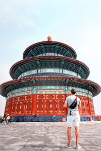 Rear view of man standing against temple