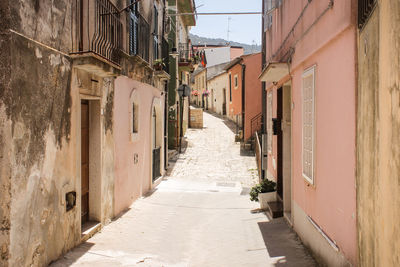 Narrow alley amidst buildings in city