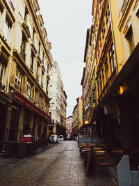 Street amidst buildings against sky in city