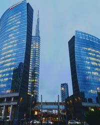 Low angle view of illuminated buildings against sky at dusk