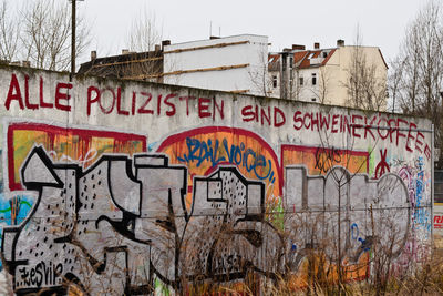 Graffiti on city against sky