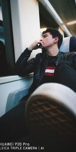 Young man using mobile phone while sitting in bus