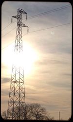 Low angle view of electricity pylon against sky