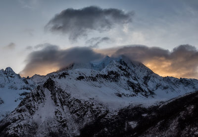 Scenic view of snowcapped mountains against sky during sunset