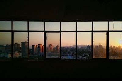 Silhouette of cityscape against sky during sunset