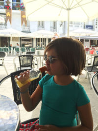 Cute girl eating food in restaurant