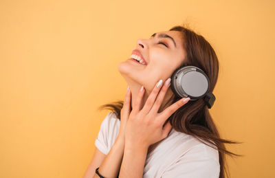 Portrait of woman smiling against white background