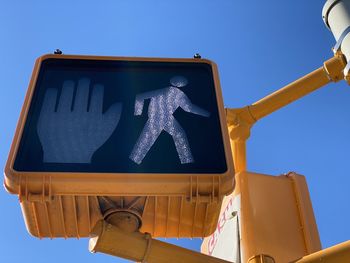 Low angle view of pedestrian crossing  sign against clear blue sky in mount vernon new york