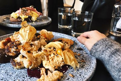 Close-up of person preparing food on table