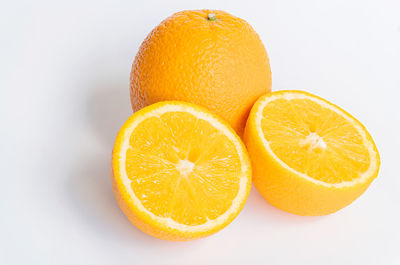 Close-up of orange fruit against white background